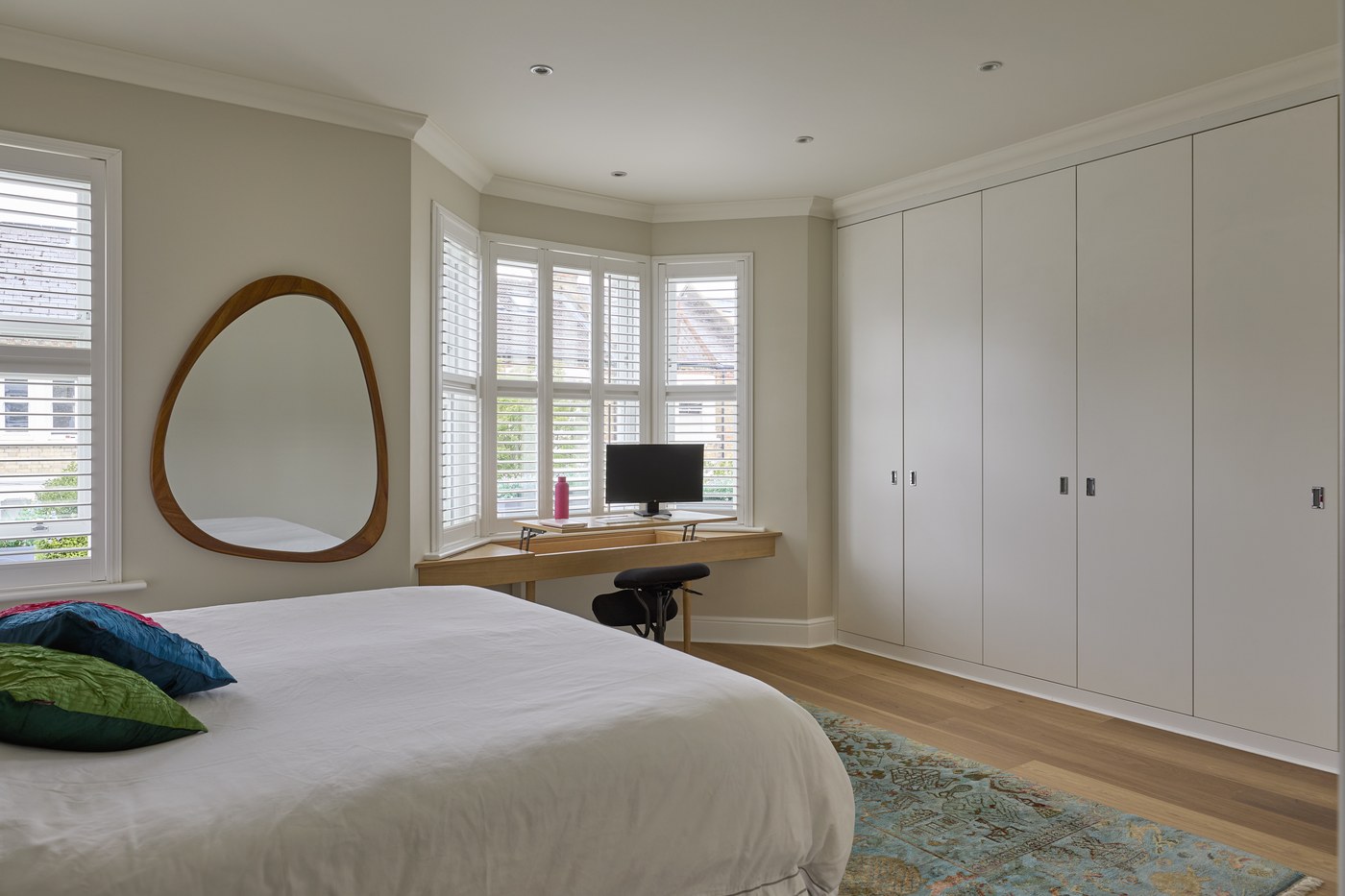 Bedroom at Achilles Road with bespoke fitted wardrobes and desk joinery