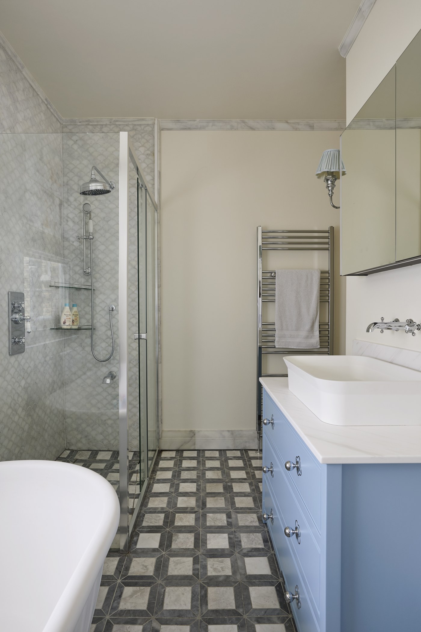 Shower room at Achilles Road with patterned tiled floor and fitted vanity