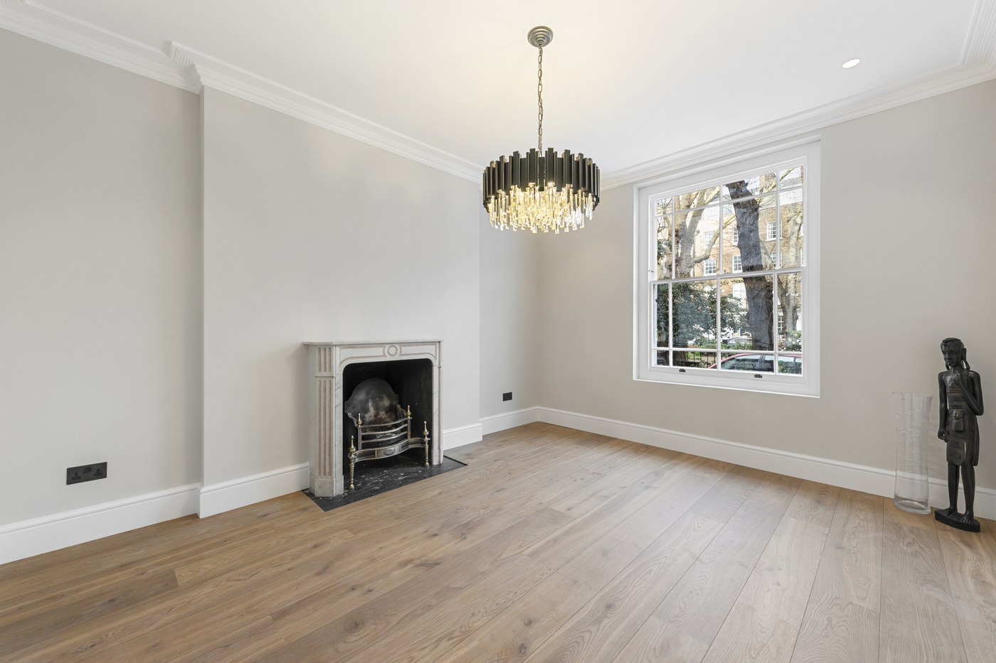 Cast-iron fireplace and restored cornice in a reception room at Brompton Square