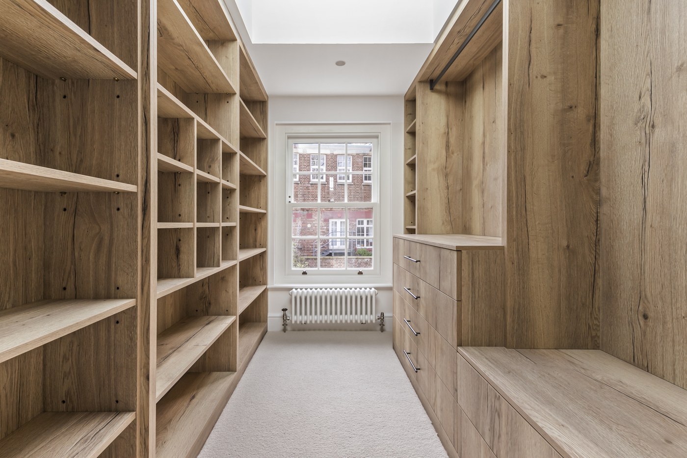 Fitted timber joinery lining the dressing corridor at Brompton Square