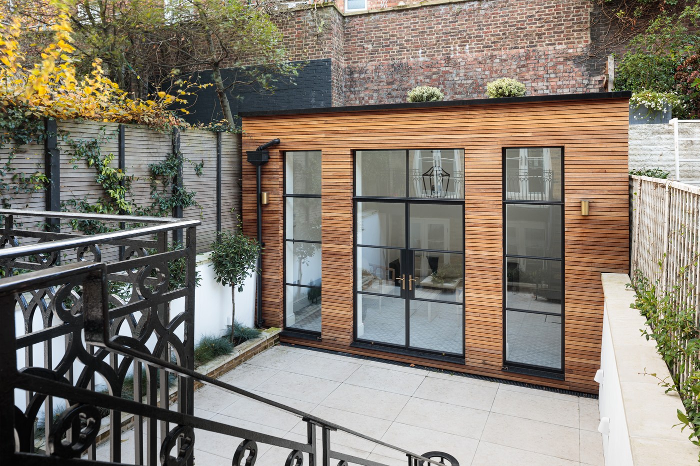 Refurbished garden outbuilding at Brompton Square, clad in timber with steel Crittall-style glazing