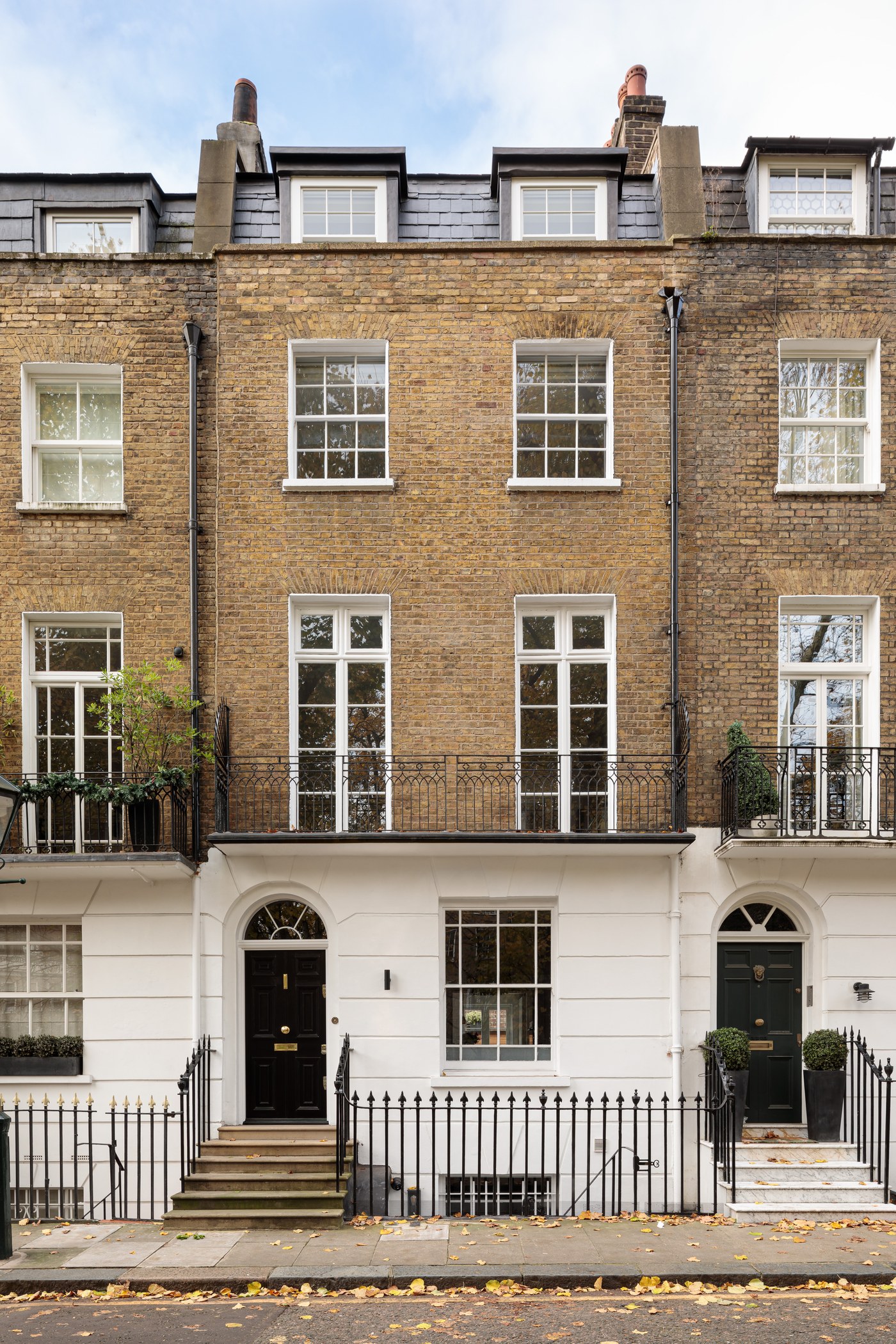 Front elevation of the Grade II listed house at Brompton Square, Knightsbridge, with restored sash windows and railings