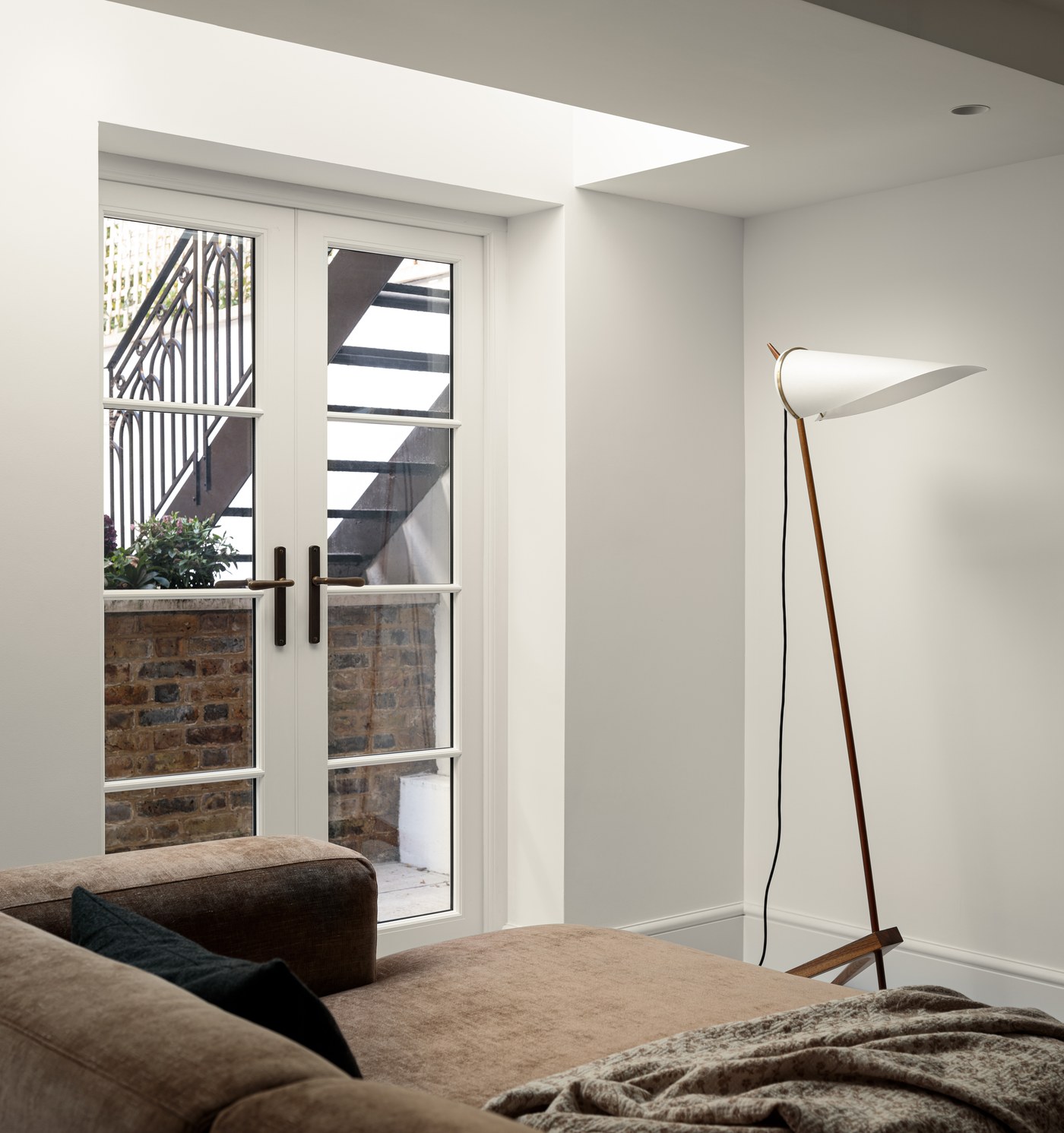 Reception room at Brompton Square with steel doors opening to the rear courtyard