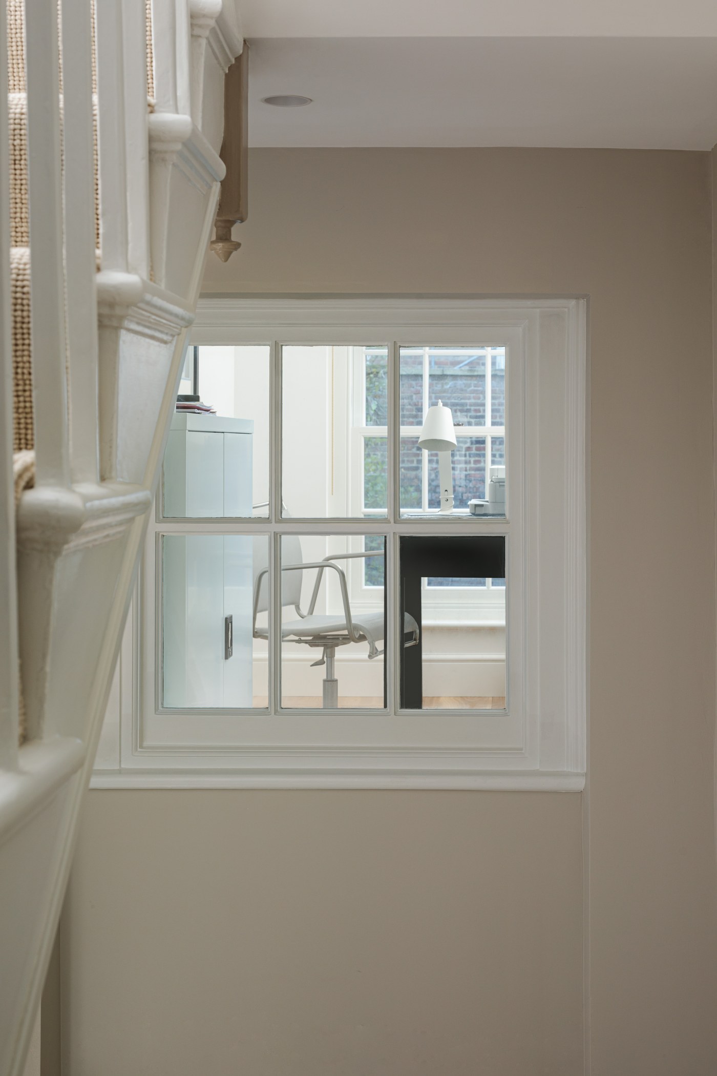 Retained staircase at Brompton Square with a new internal window borrowing light from the stair