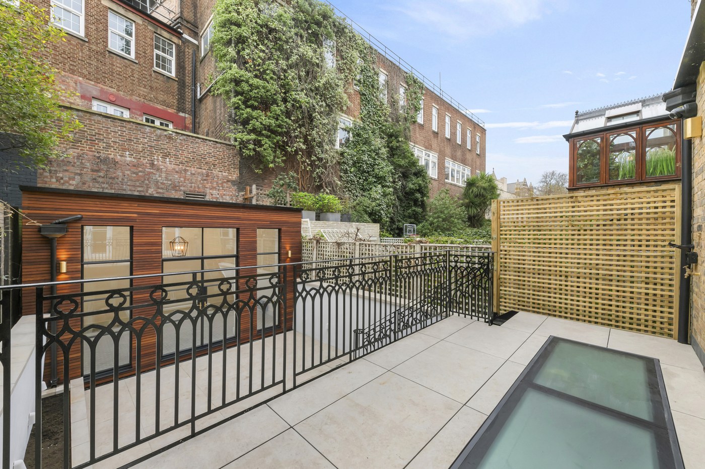 Rear terrace at Brompton Square with bespoke metal balustrade over the basement rooflight