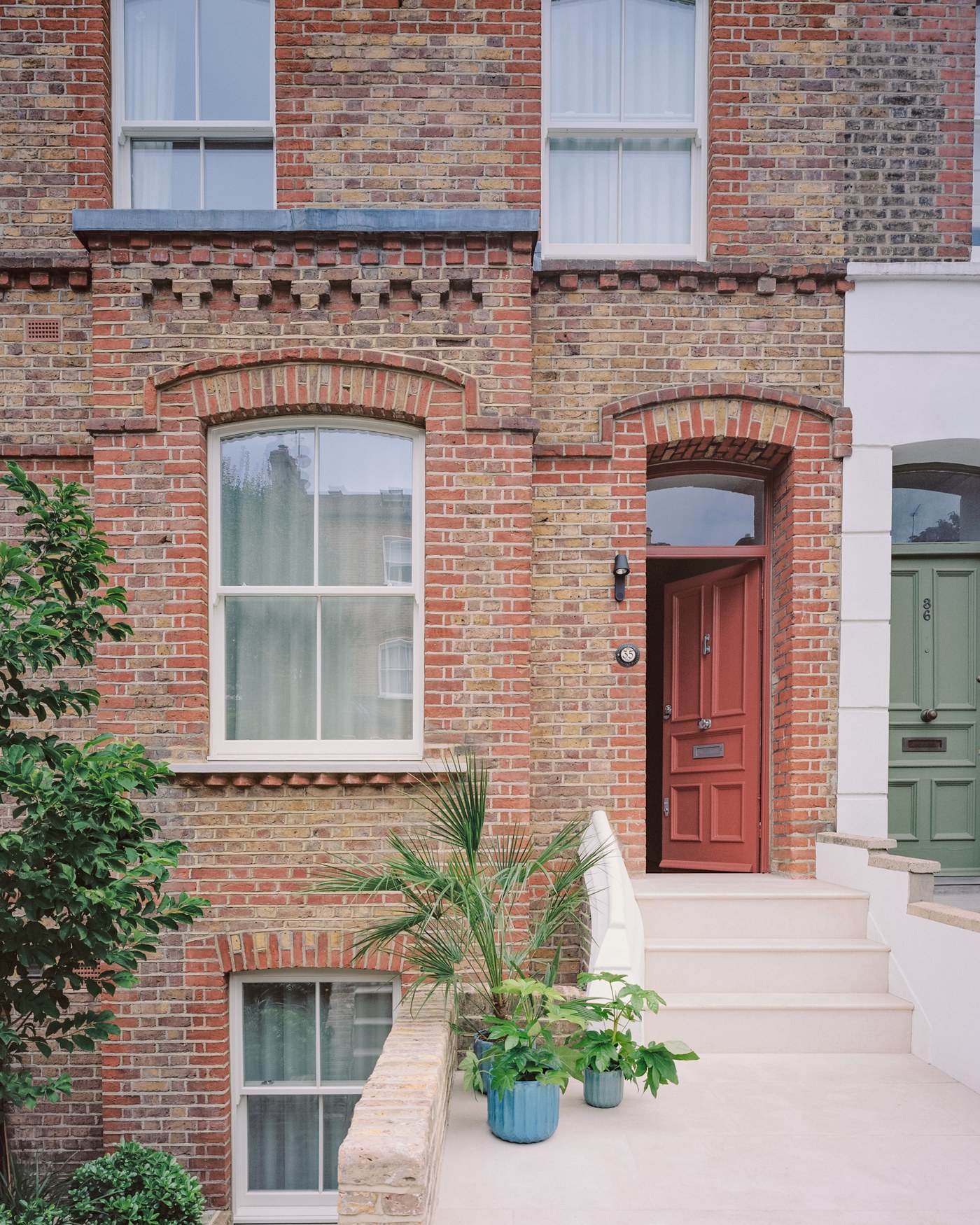 Caithness Road W14 — the front of the house, with restored brickwork, timber sash windows and new stone entrance steps