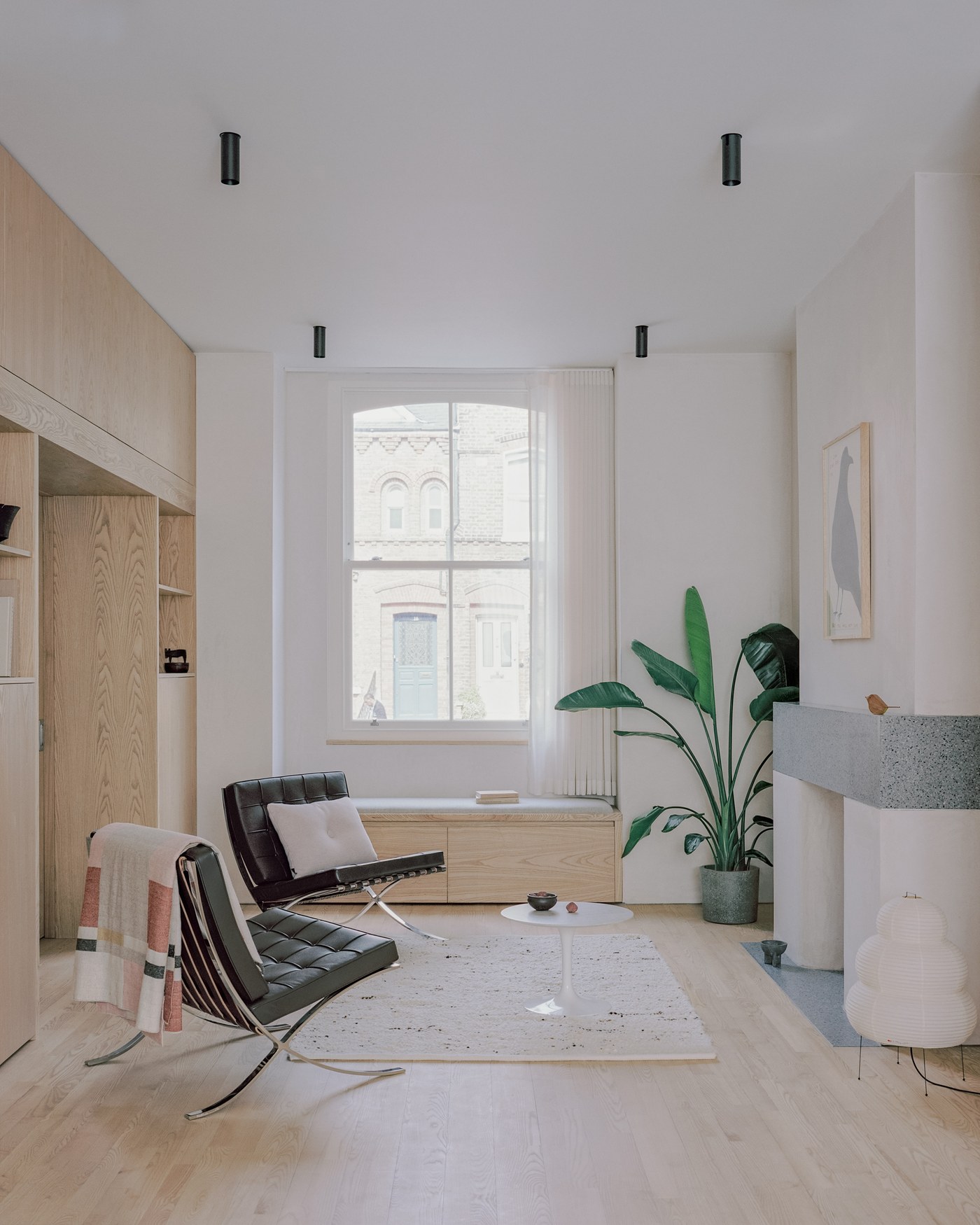 Caithness Road W14 — front reception room with a timber sash window, built-in ash joinery and window seat