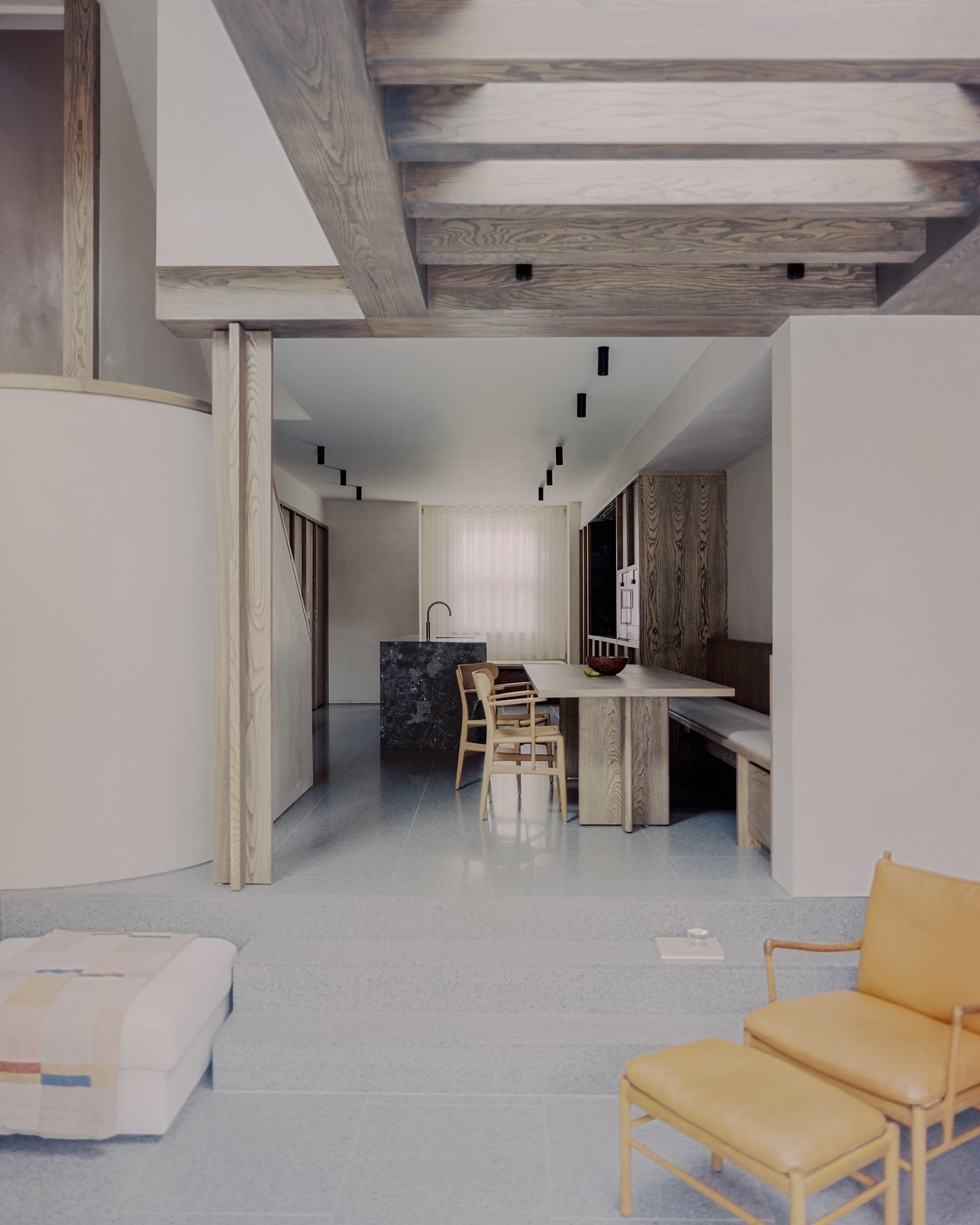 Caithness Road W14 — view along the ground floor from the reception room, beneath a timber beam and post, to the dining table and kitchen