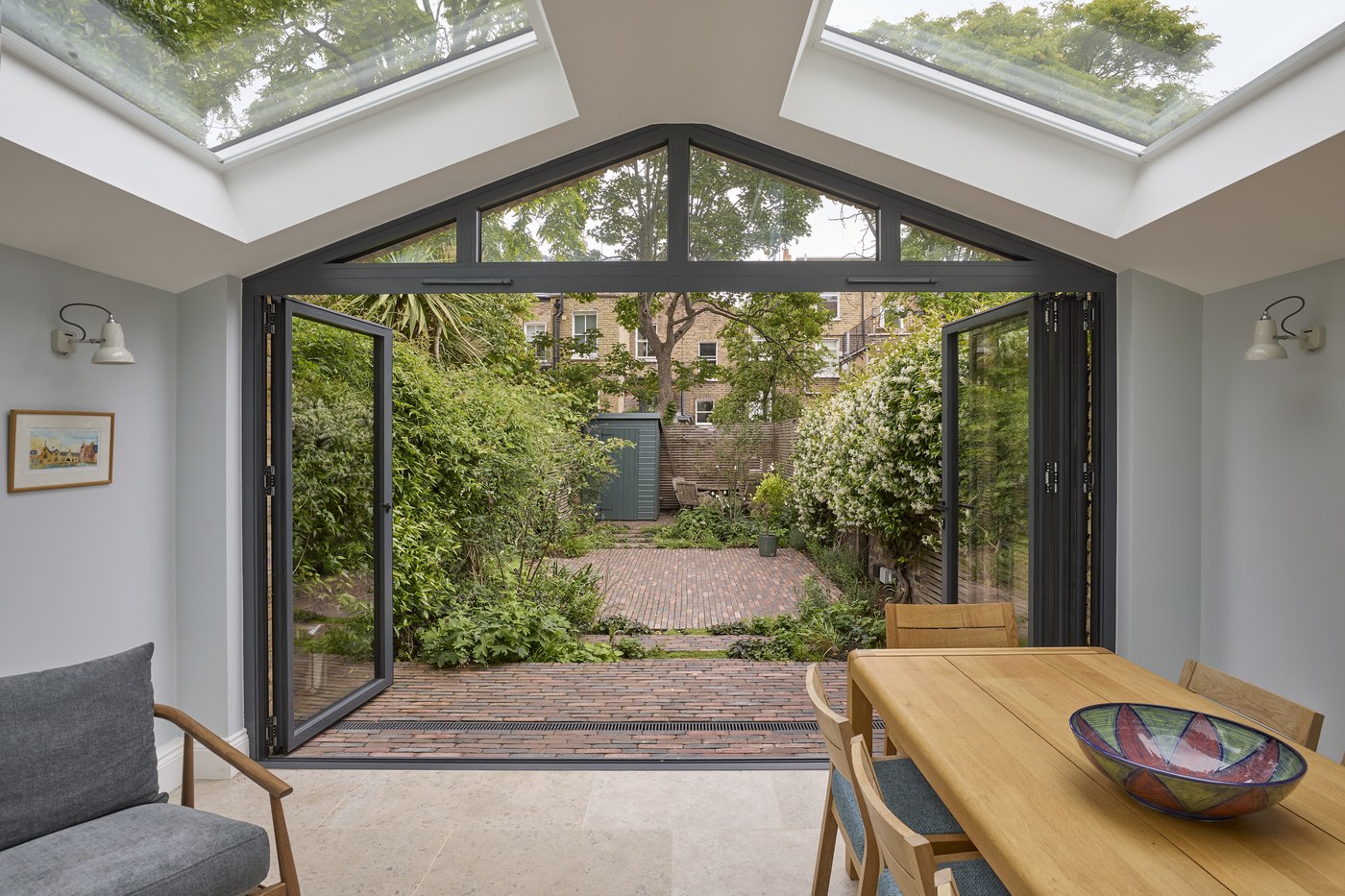 Extension at Ceylon Road with the doors folded back to the garden, lit from above by rooflights