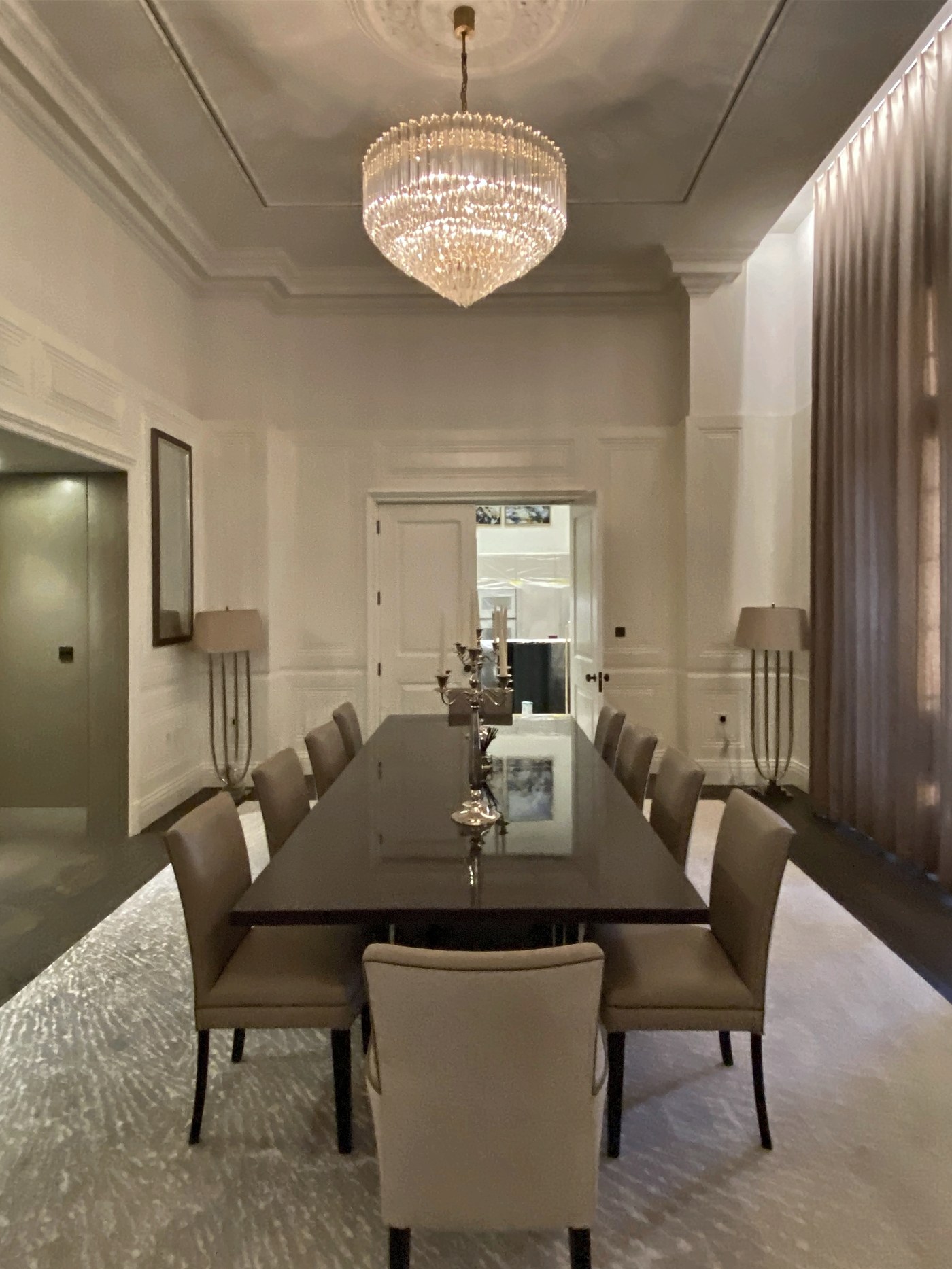 Panelled dining room at Connaught Place, with a mirrored recess to the end wall