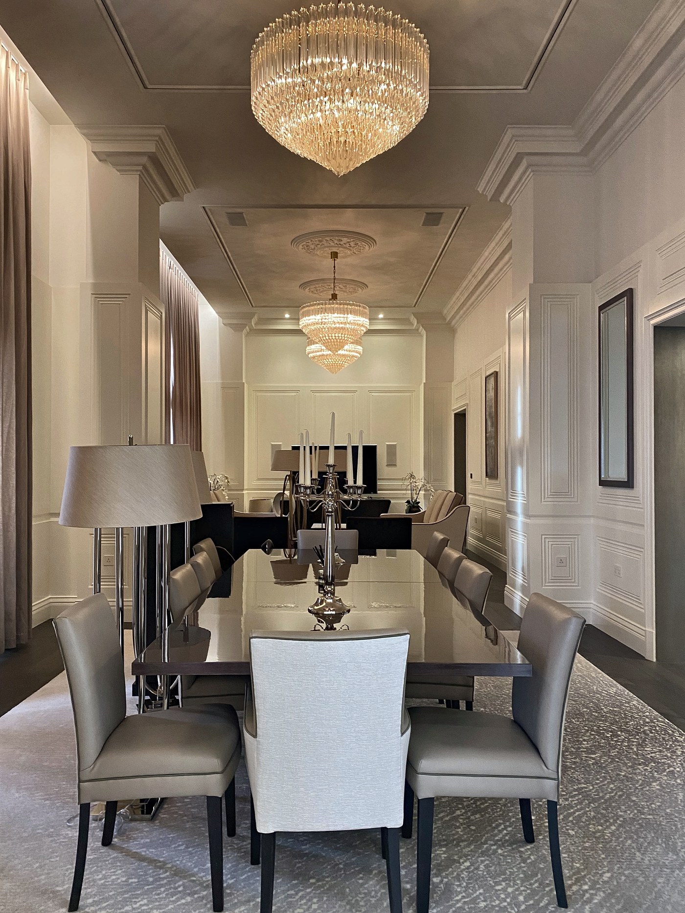 The reception rooms at Connaught Place seen in sequence, lit by chandeliers set into the panelled ceiling