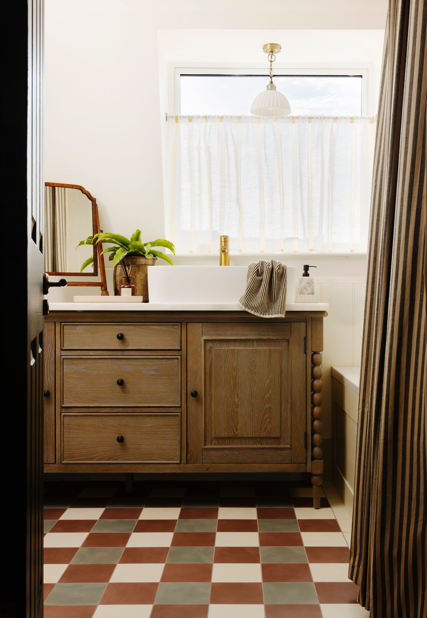 Bathroom at Garratt Lane with a timber vanity and chequerboard floor