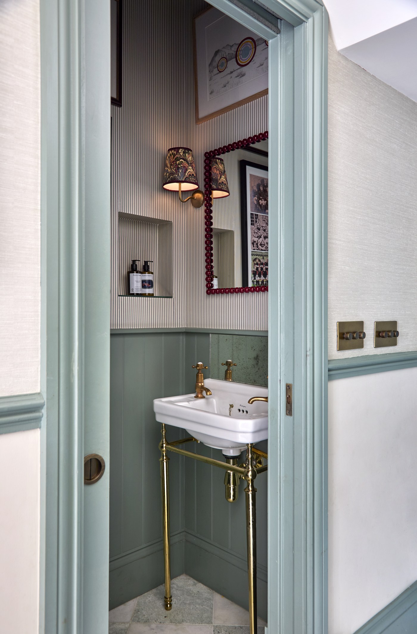 Ground-floor cloakroom at Melrose Gardens with panelled joinery and a wall-hung basin