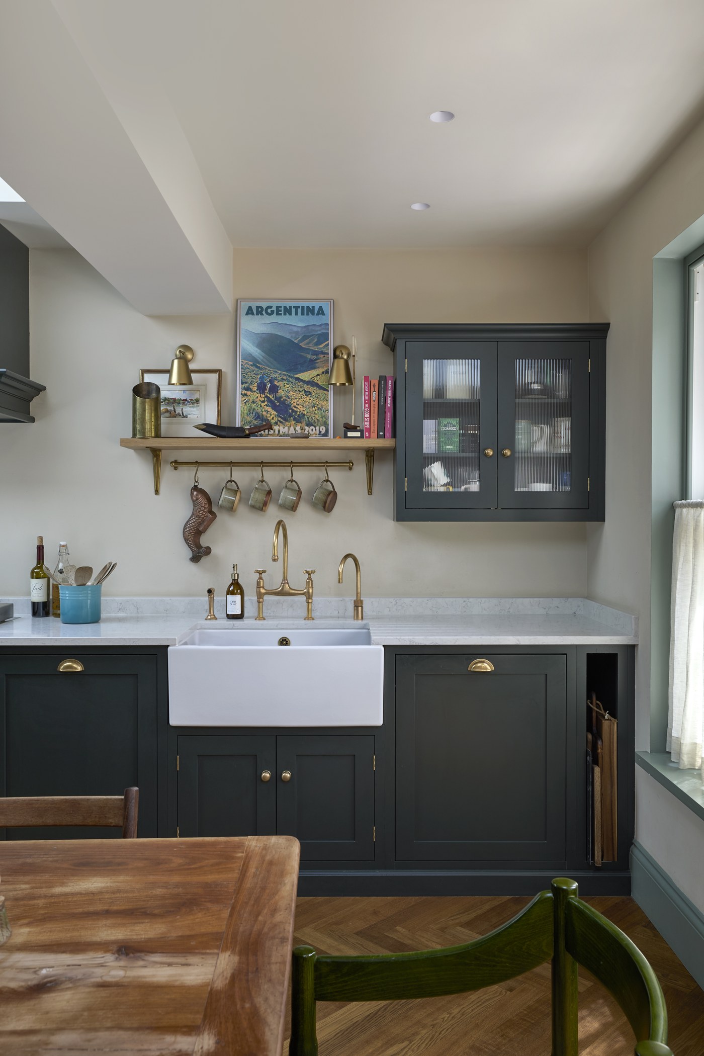 Kitchen detail at Melrose Gardens: Belfast sink, brass tap and stone worktop