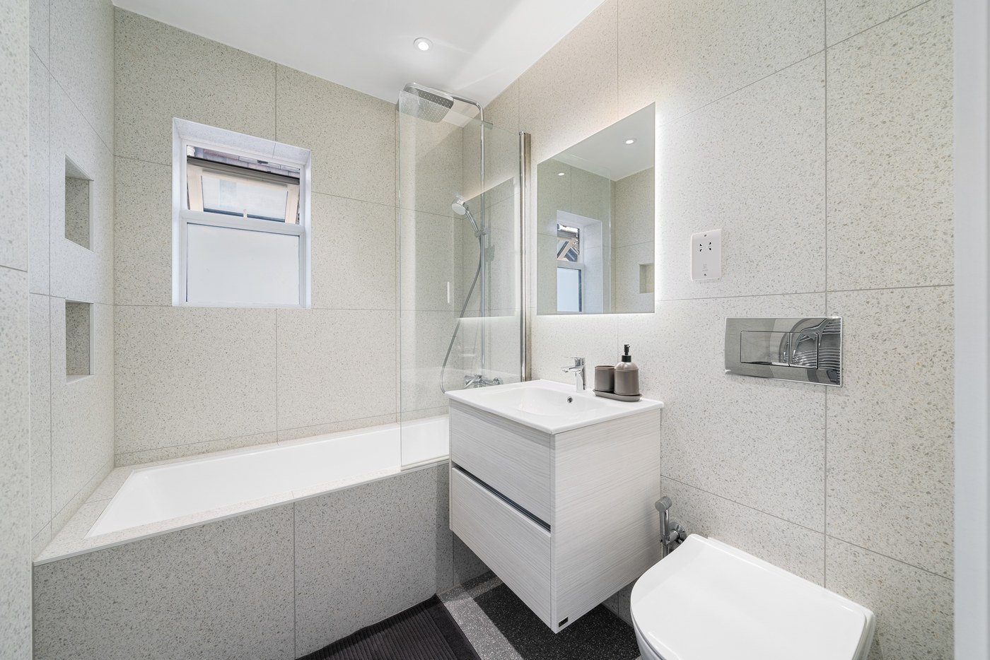 New bathroom at Millway with fitted vanity and bath screen