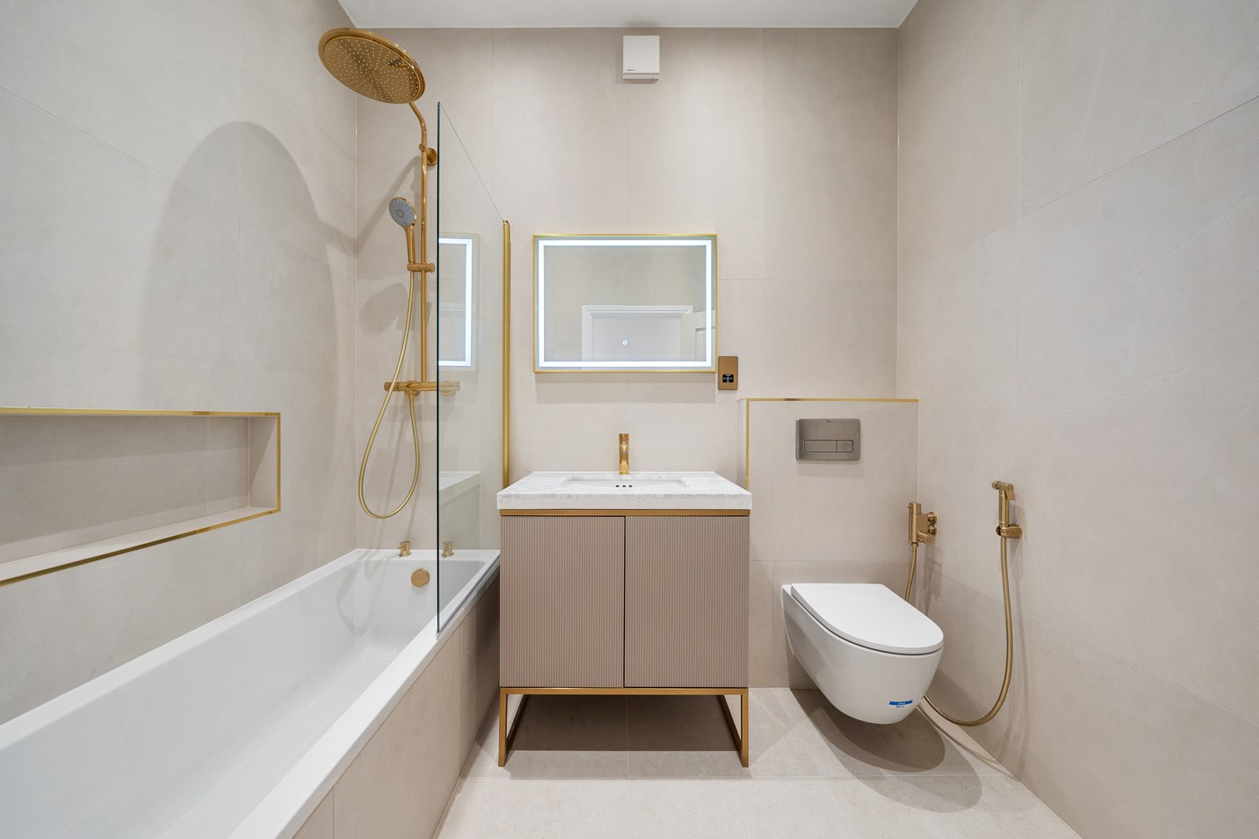Bathroom at St John's Wood Road with brass fittings and a fluted vanity