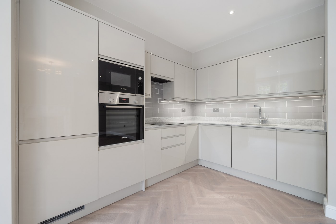 New kitchen at St John's Wood Road with integrated appliances and stone splashback